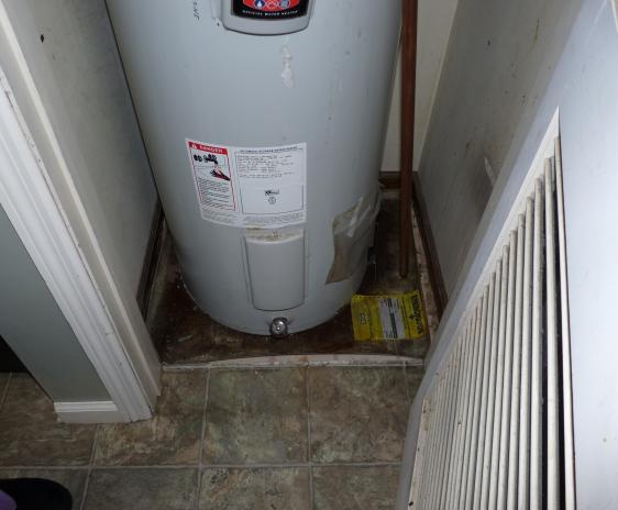The seeping water heater (with no drain pan) in the left closet.